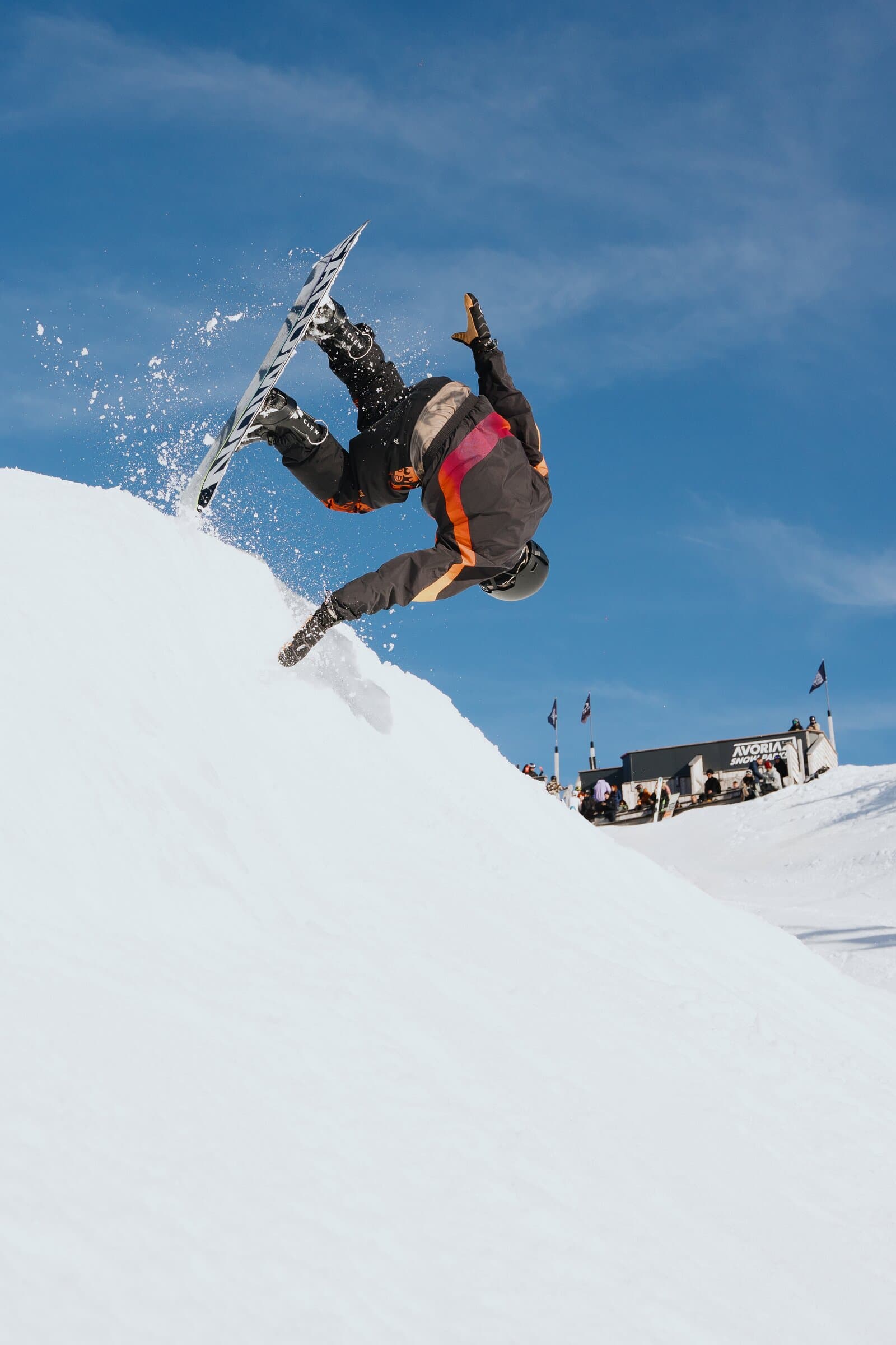 Snowboarder doing backflip with Clew Step-In Bindings
