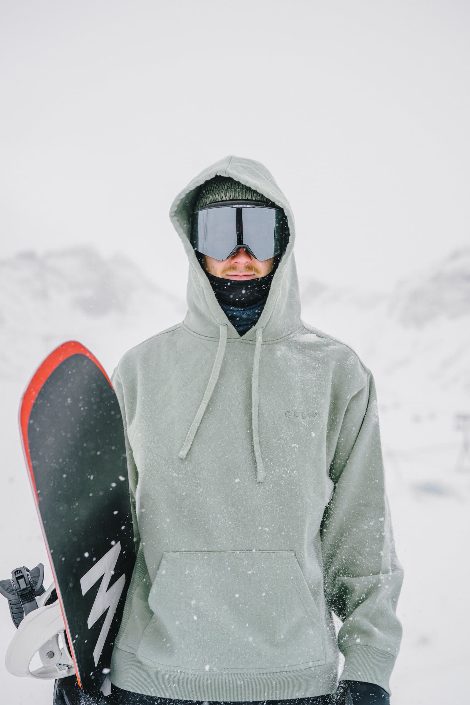 Snowboarder with Clew gear in snowy mountains